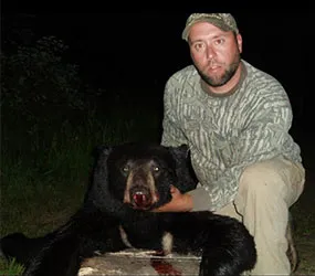 Hunter with a harvested black bear