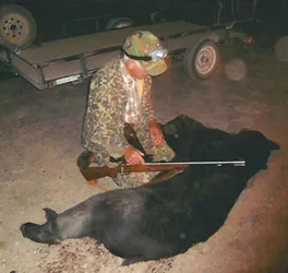 Hunter with a harvested black bear