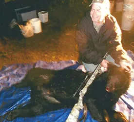 Hunter with a harvested black bear