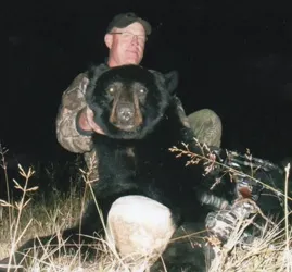 Hunter with a harvested black bear