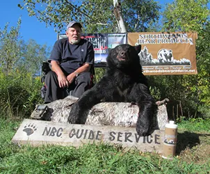 Hunter with a harvested black bear