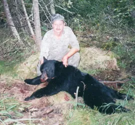 Hunter with a harvested black bear