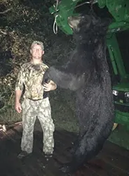 Hunter with a harvested black bear