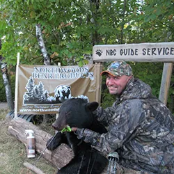 Hunter with a harvested black bear