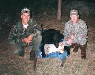 Hunter with a harvested black bear