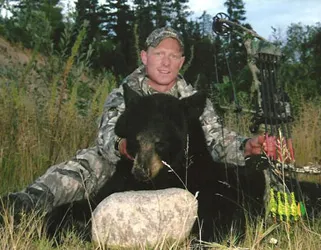 Hunter with a harvested black bear