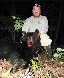 Hunter with a harvested black bear