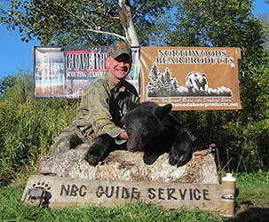 Hunter with a harvested black bear