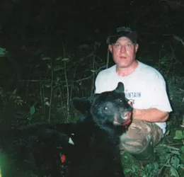 Hunter with a harvested black bear
