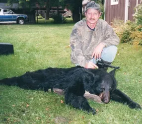 Hunter with a harvested black bear