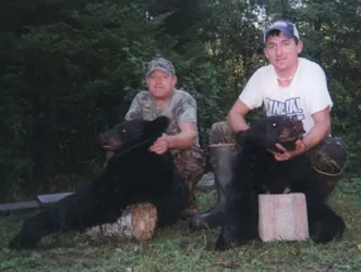 Hunter with a harvested black bear