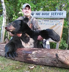 Hunter with a harvested black bear