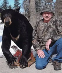 Hunter with a harvested black bear