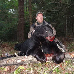 Hunter with a harvested black bear
