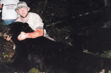 Hunter with a harvested black bear