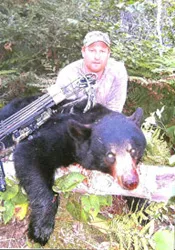 Hunter with a harvested black bear