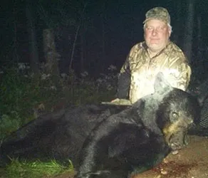 Hunter with a harvested black bear