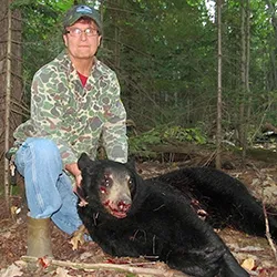 Hunter with a harvested black bear