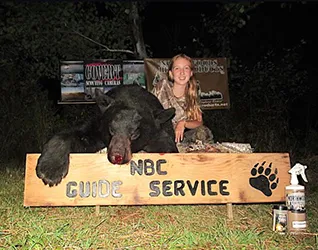 Hunter with a harvested black bear