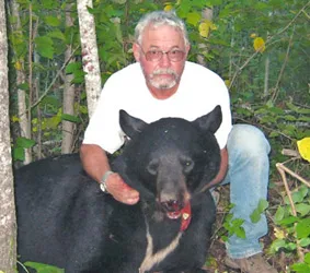 Hunter with a harvested black bear