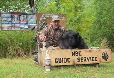 Hunter with a harvested black bear