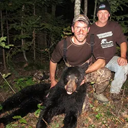 Hunter with a harvested black bear