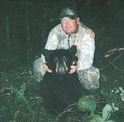 Hunter with a harvested black bear
