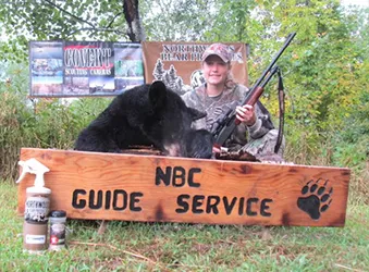 Hunter with a harvested black bear