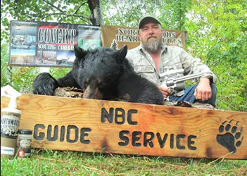Hunter with a harvested black bear