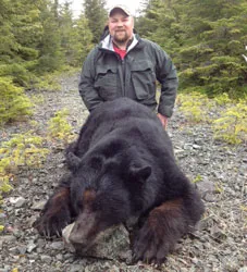 Hunter with a harvested black bear