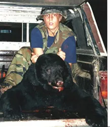 Hunter with a harvested black bear