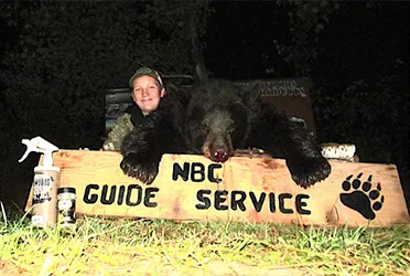 Hunter with a harvested black bear