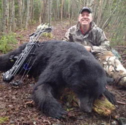Hunter with a harvested black bear