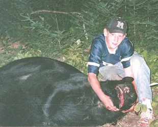 Hunter with a harvested black bear