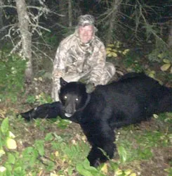 Hunter with a harvested black bear