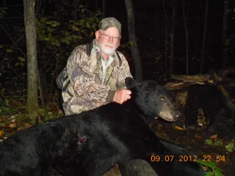 Hunter with a harvested black bear