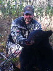 Hunter with a harvested black bear