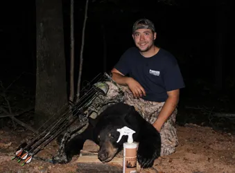 Hunter with a harvested black bear