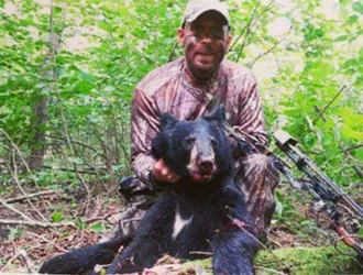 Hunter with a harvested black bear