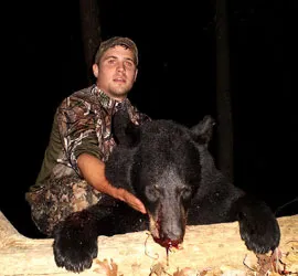 Hunter with a harvested black bear