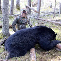 Hunter with a harvested black bear
