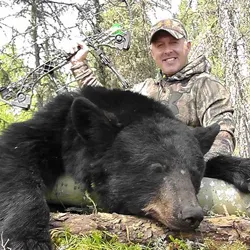 Hunter with a harvested black bear