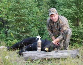 Hunter with a harvested black bear