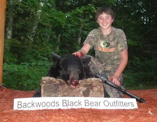 Hunter with a harvested black bear