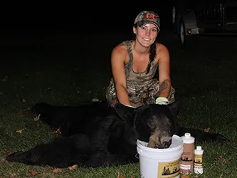 Hunter with a harvested black bear