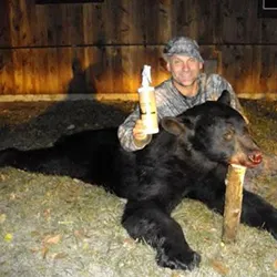 Hunter with a harvested black bear