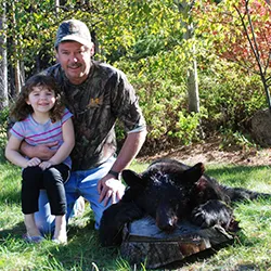 Hunter with a harvested black bear