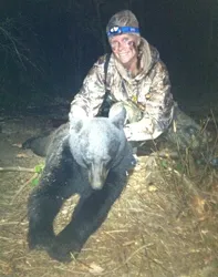 Hunter with a harvested black bear