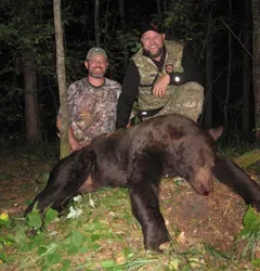 Hunter with a harvested black bear