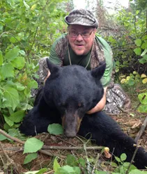 Hunter with a harvested black bear